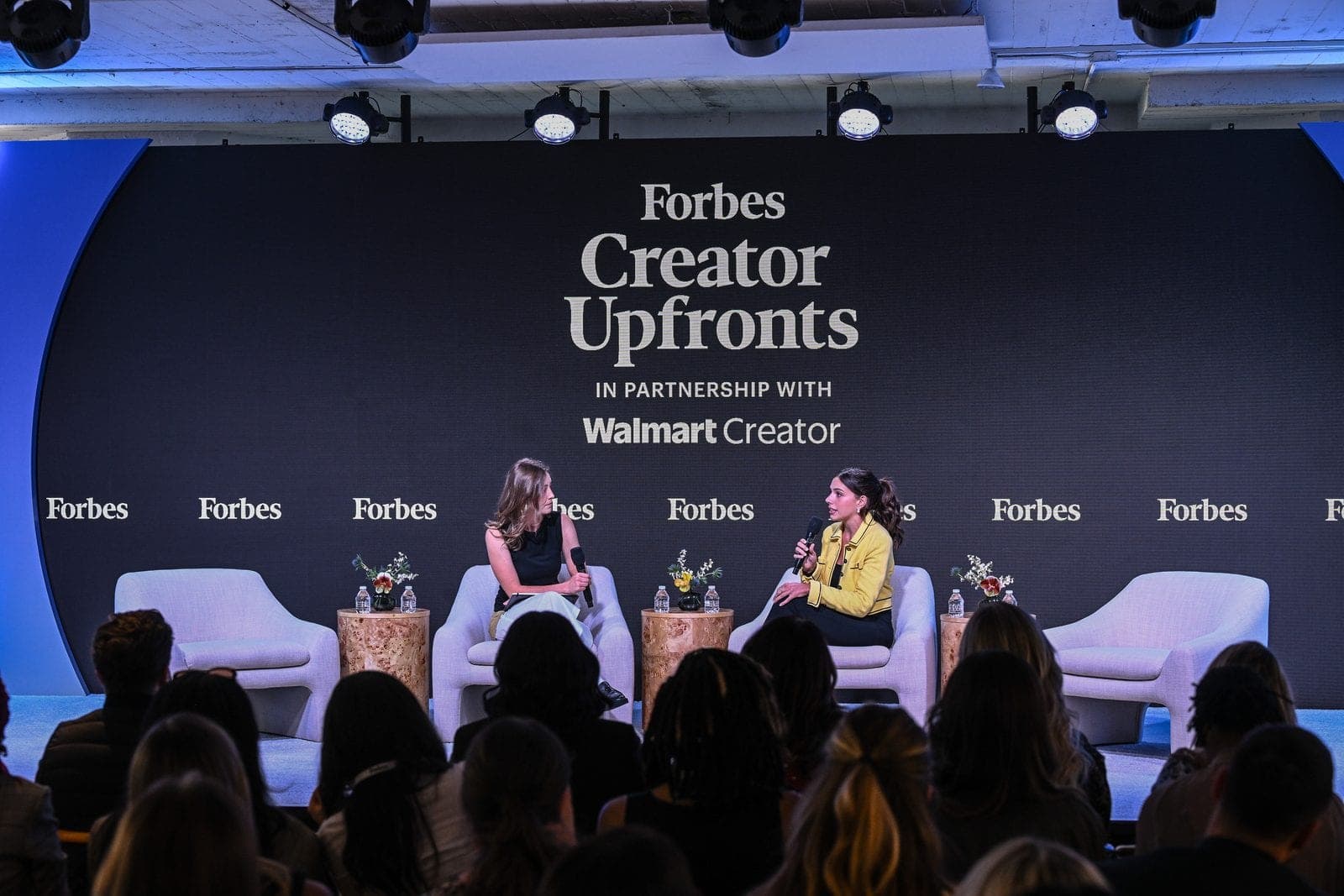 Taylor Price on stage at the Forbes Creator Upfronts, with Forbes and Walmart Creator on the backdrop.